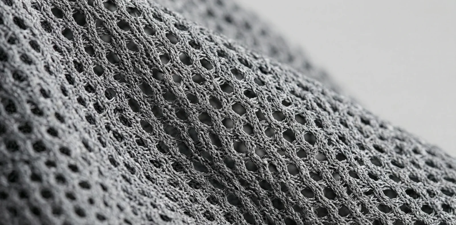 wholesale soccer jersey fabric close up showing 160 GSM moisture wicking mesh texture