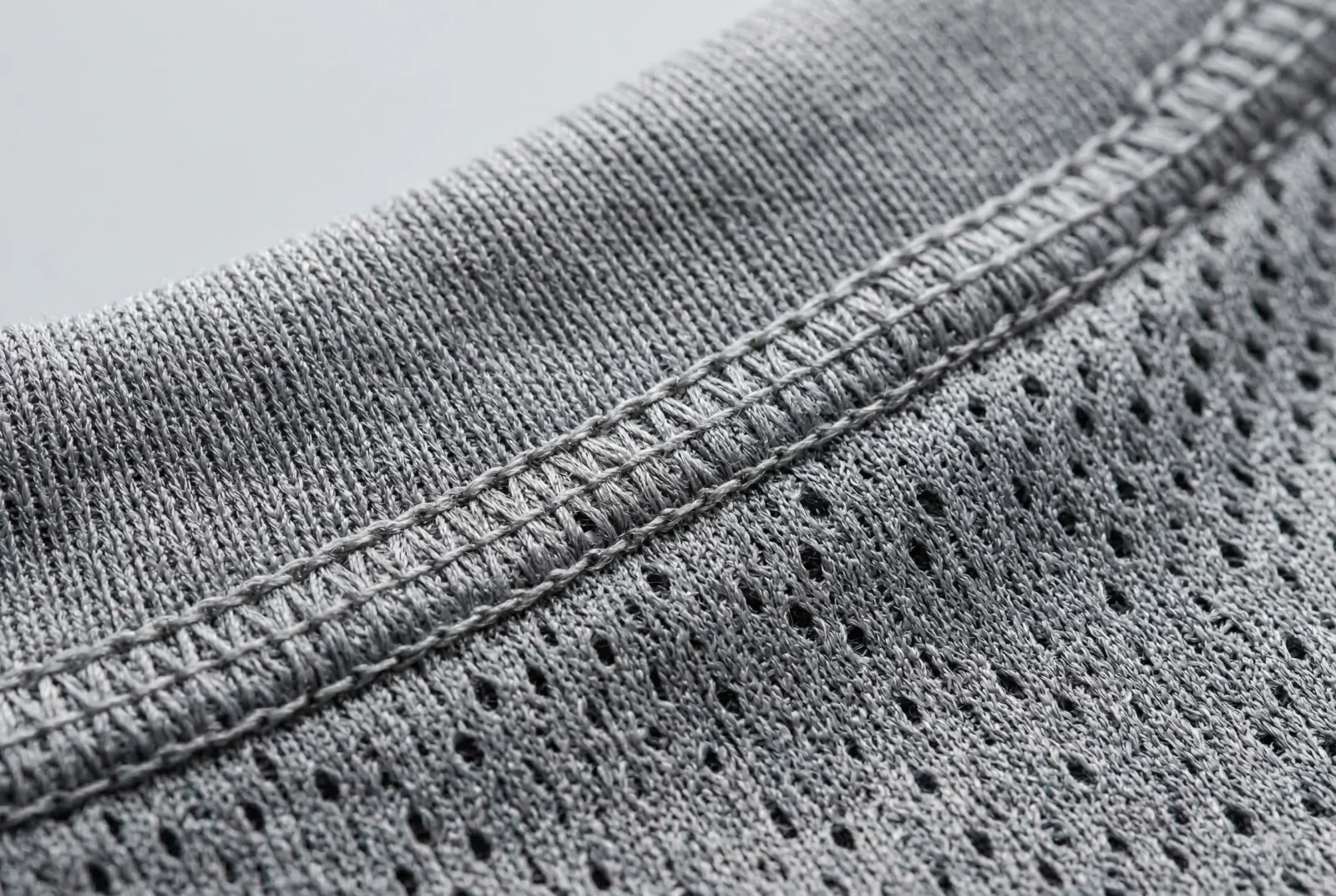 wholesale soccer jersey close up displaying 160 GSM moisture wicking mesh and reinforced collar stitching