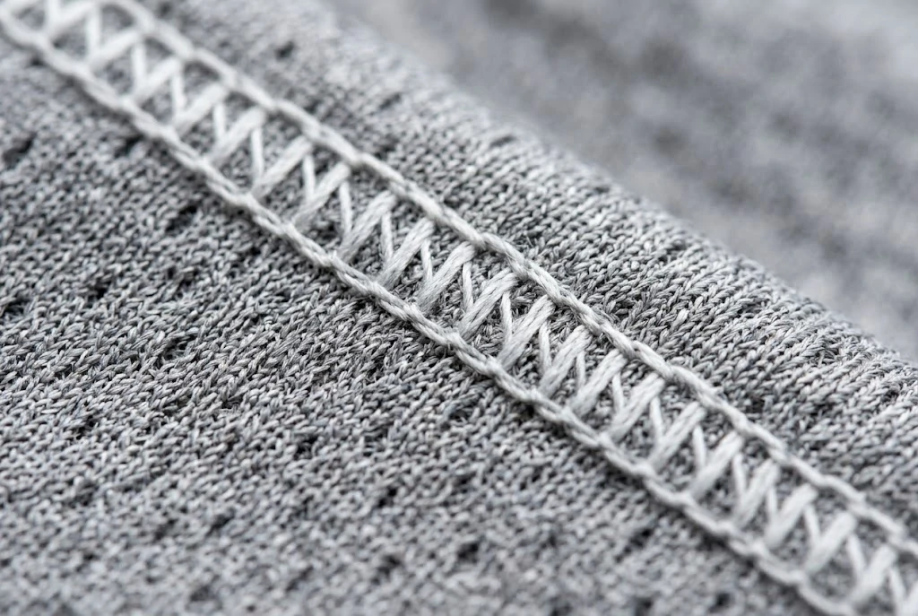 extreme close-up of moisture-wicking fabric and durable stitching on a blank sports jersey.